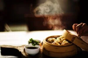 Steamed frozen dumplings in a bamboo steamer